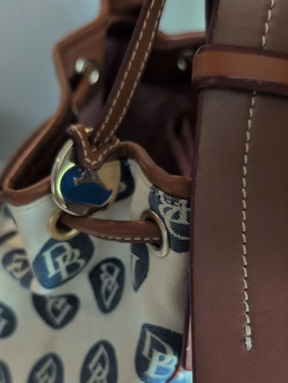 Dooney & Bourke Cream Canvas DB Logo Drawstring Shoulder Bag with Brown Trim